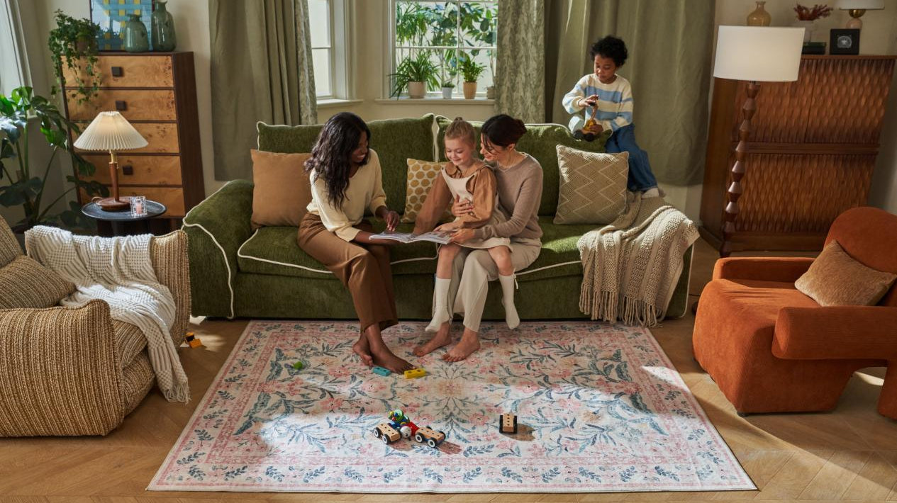 Family on floral rug in cozy, modern living room