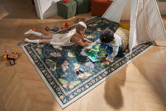Kids drawing on floral butterfly rug under play tent
