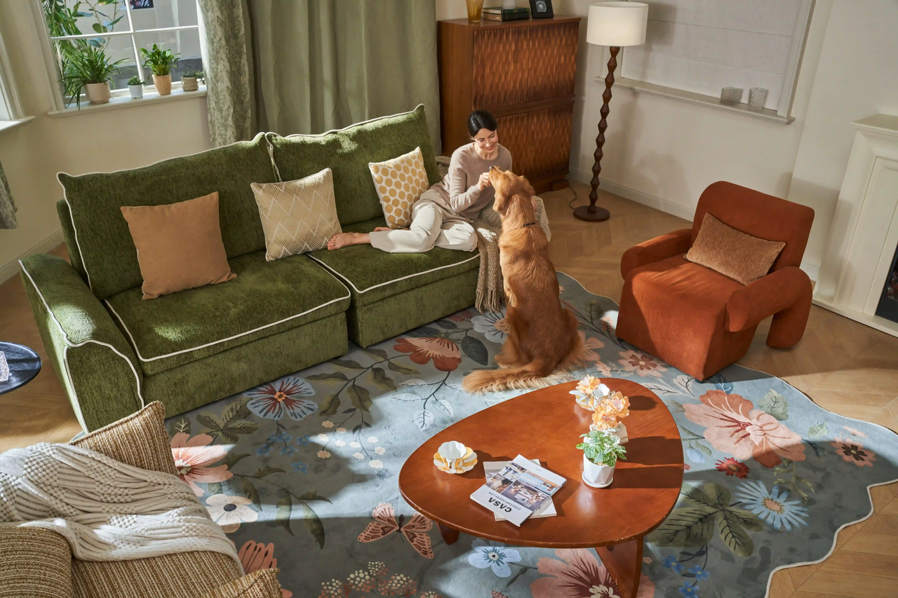 Cozy living room with a floral Living Room Rug, green sofa, and warm decor.