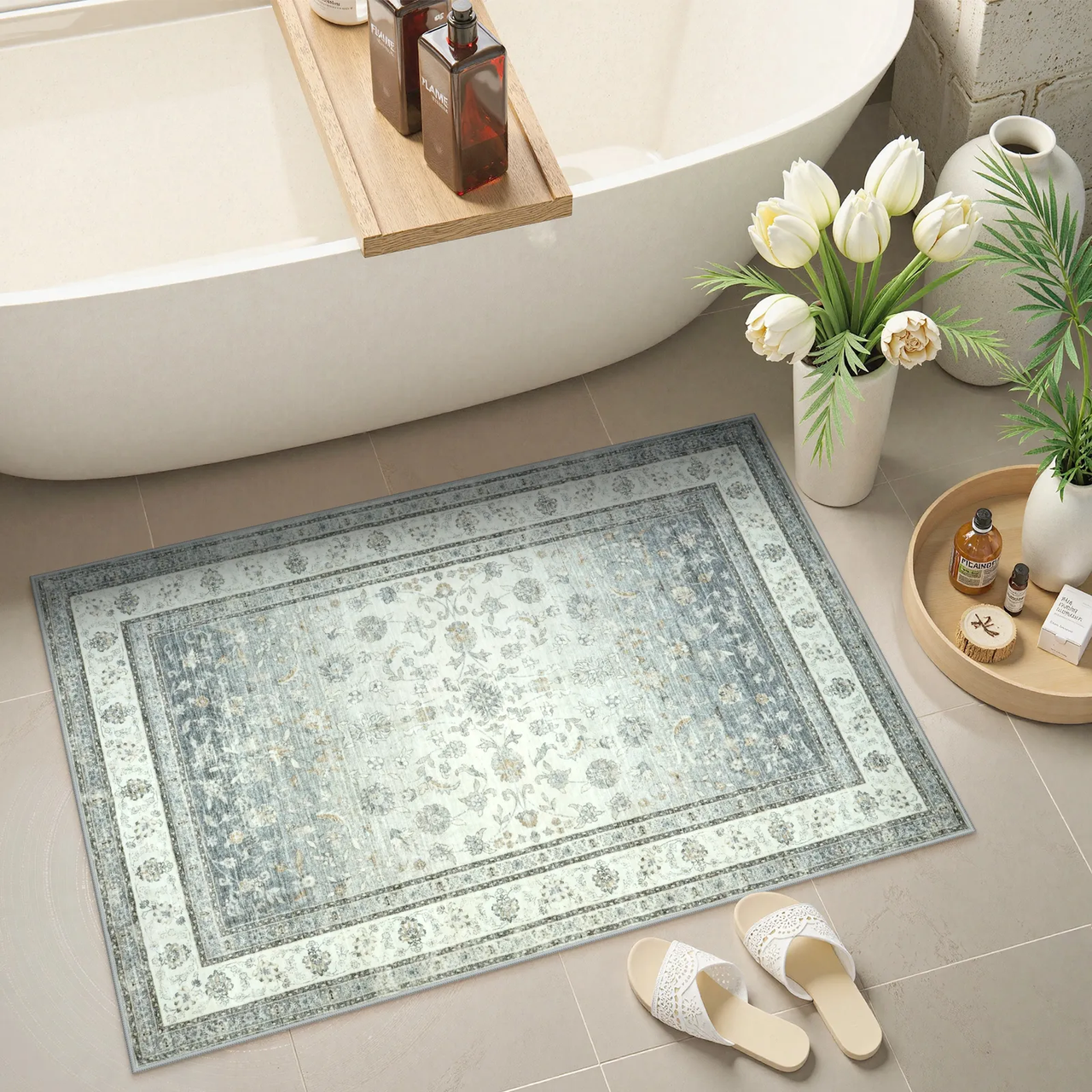 Light blue vintage bath rug beside freestanding tub
