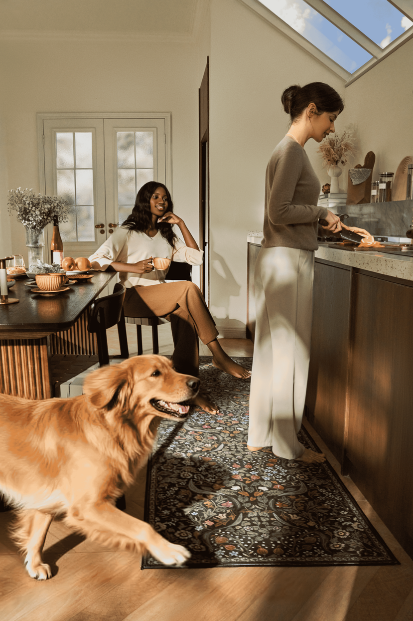 Floral kitchen rug with women, dog, and bright skylight