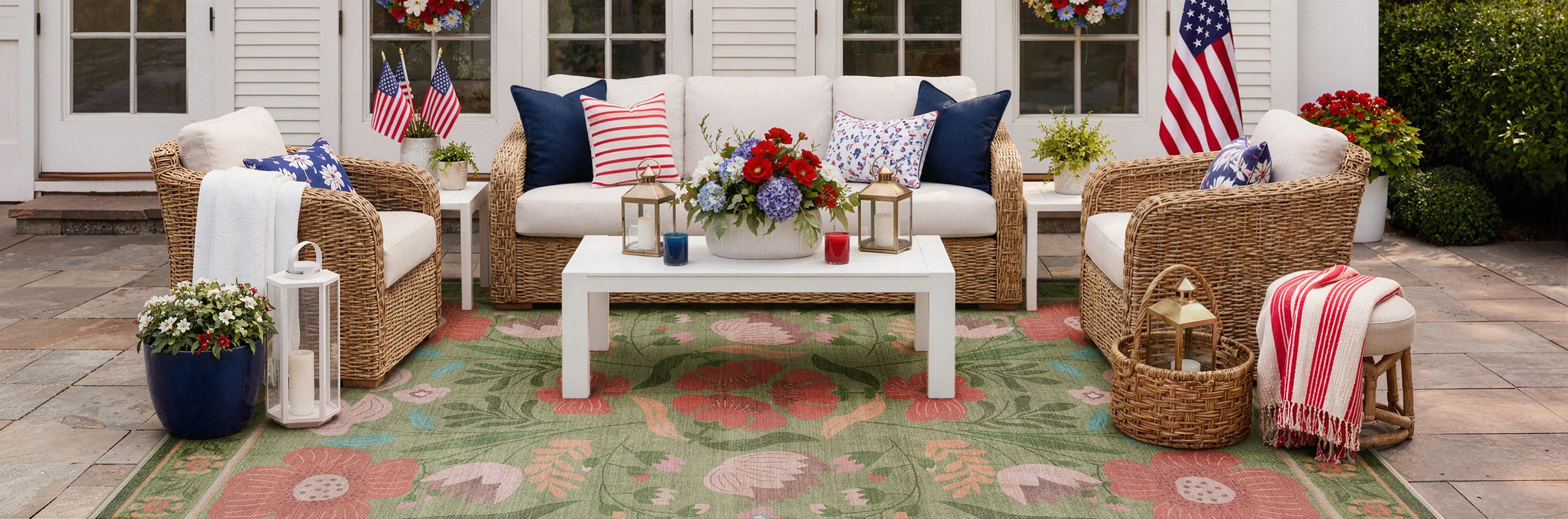 Outdoor patio with wicker furniture, cushions, and decorative items on a colorful rug.