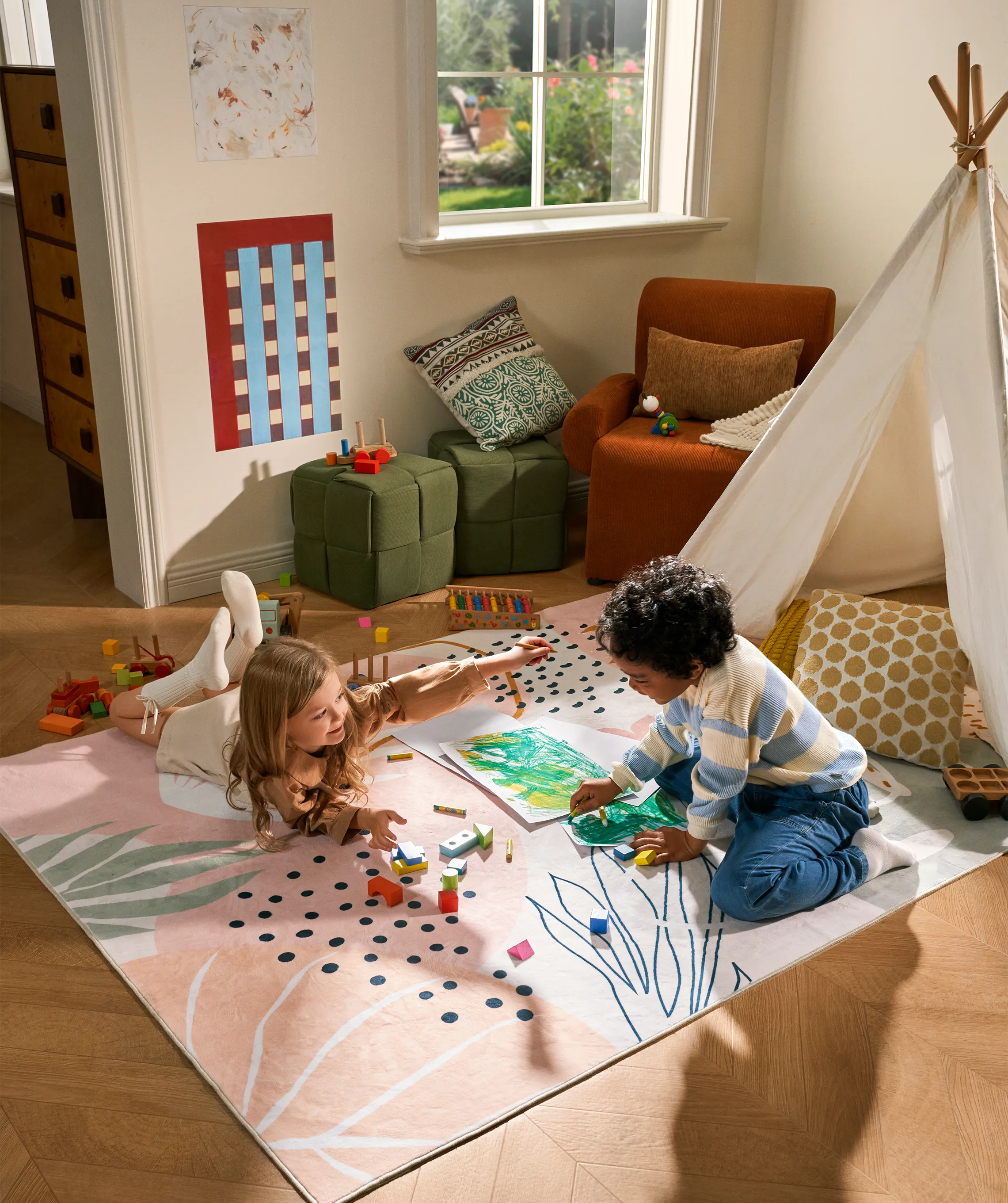 Children playing on a colorful rug in a room with a teepee and furniture.